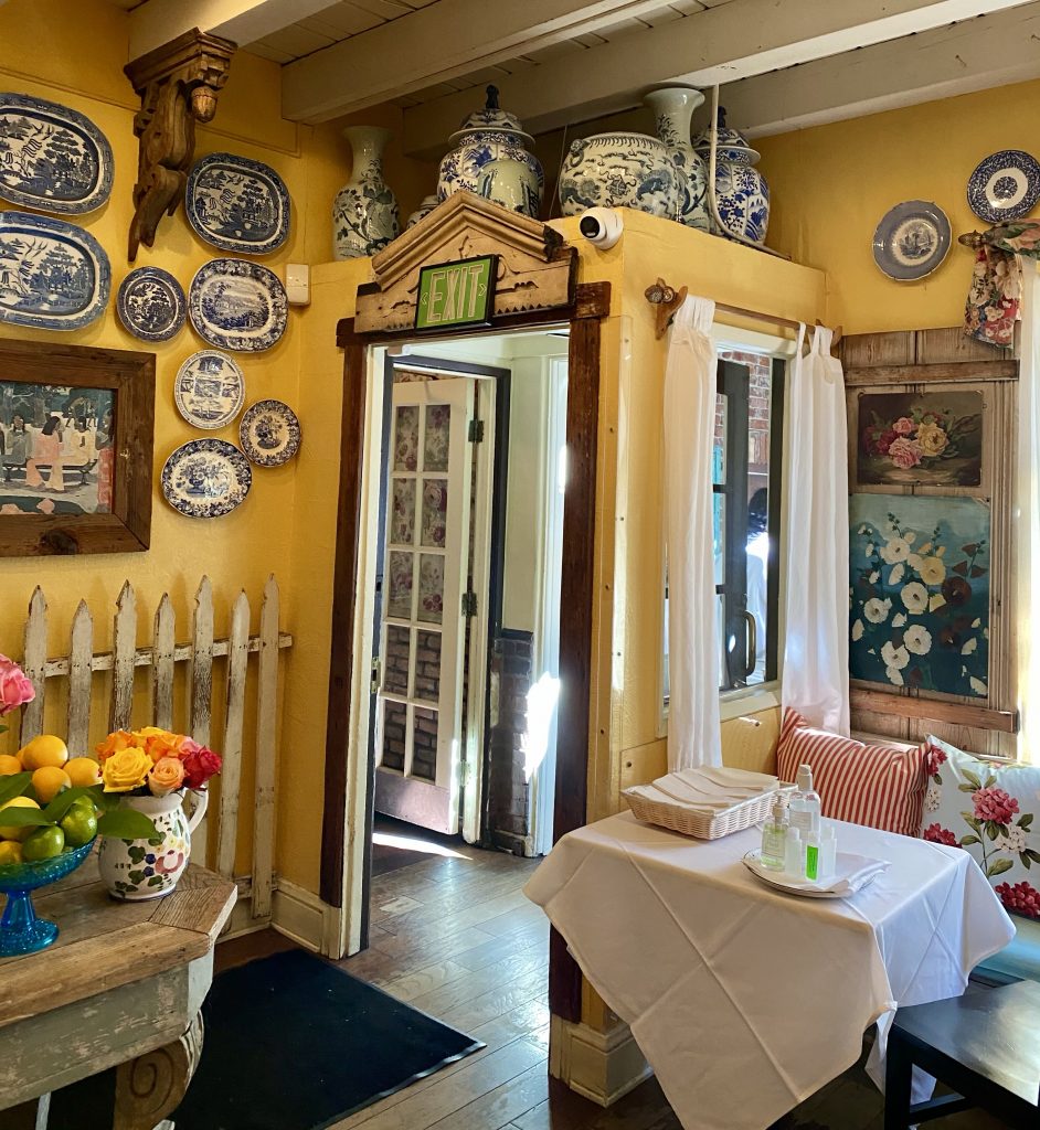 The Ivy, blue and white china, yellow walls, indoor picket fence