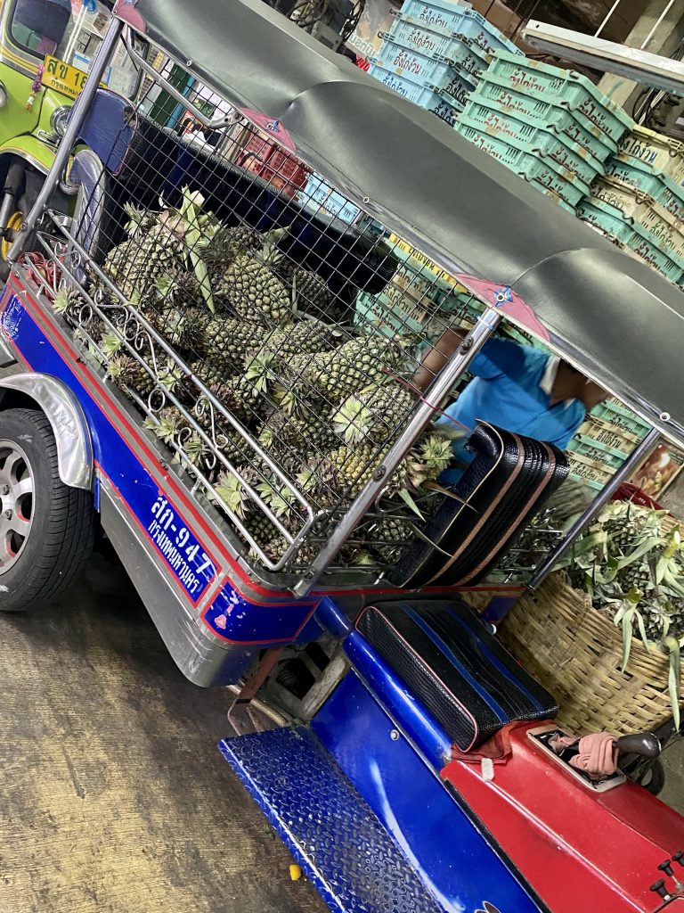 Fresh cut pineapples, tuk tuk filled with pineapples, Bangkok produce market, Pak Khlong Talat