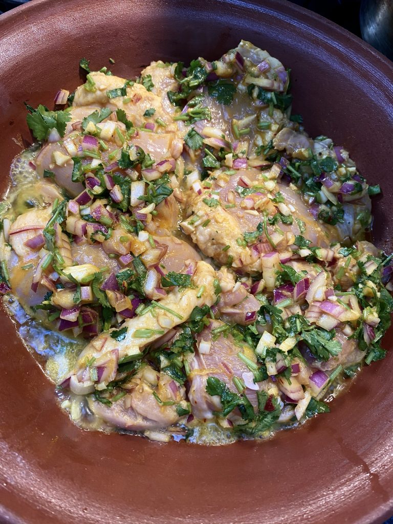 clay tagine, easy tagine recipe, cilantro, bunch of cilantro, chopped cilantro, red onions, olive oil, spices, marinade, chicken thighs, boneless skinless chicken thighs