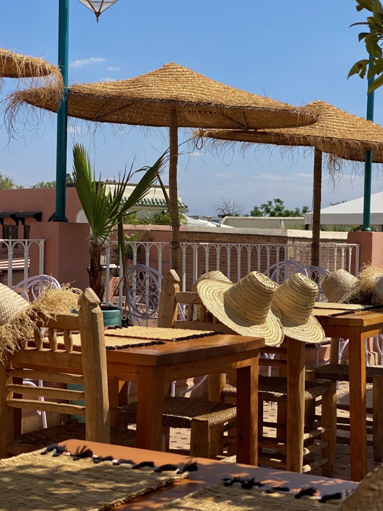 rooftop dining, marrakesh, morroco, woven umbrellas, woven hats, Medina, palm trees, pom pom hats, tasseled placemats, handwoven goods, views of the Medina, Terrace la Maison des Épices