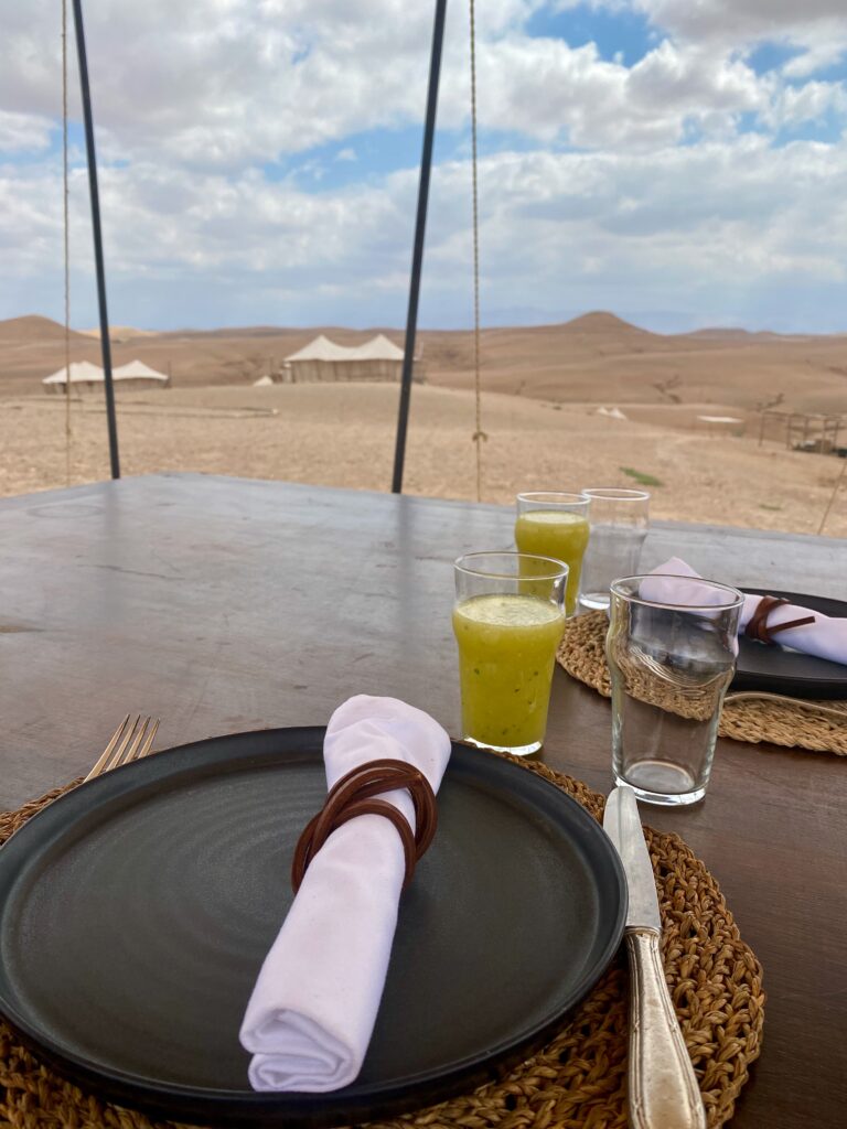 lunch in the dessert, fresh juice, leather tied white napkins, Scarabeo Camp, elegant food in a rustic setting, Agafy desert, Morocco, tent dining, nomadic life, luxury tent living, indoor outdoor living, indoor outdoor dining, elegant food in a rustic setting 