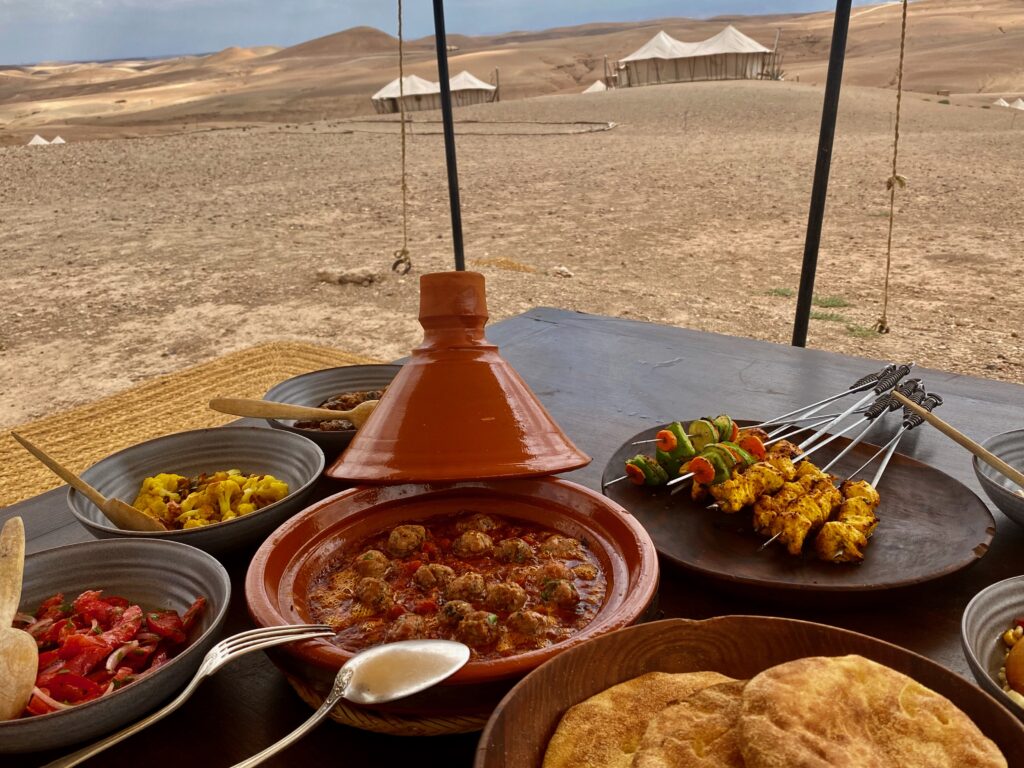 lunch in the dessert, chicken kababs, kafta, batbout, flatbread, tagine, Scarabeo Camp, elegant food in a rustic setting, Agafy desert, Morocco, tent dining, nomadic life, luxury tent living, indoor outdoor living, indoor outdoor dining