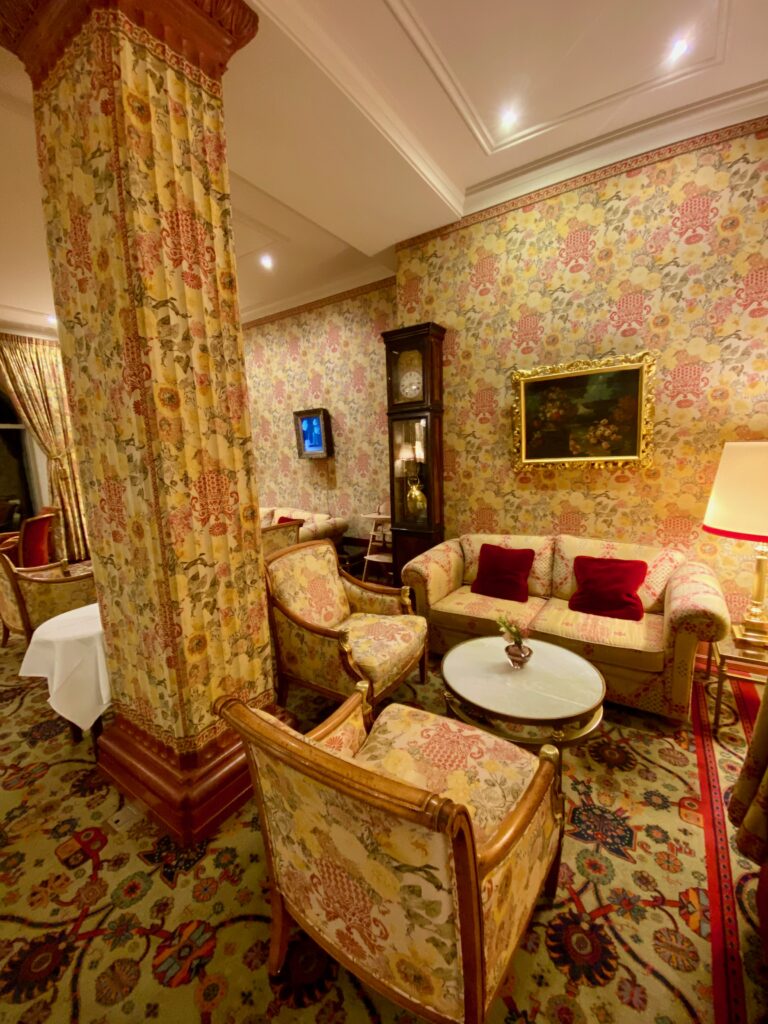 Hotel Kulm, St. Moritz, gold and ruby wallpaper, gold and ruby upholstery, gold and ruby curtains