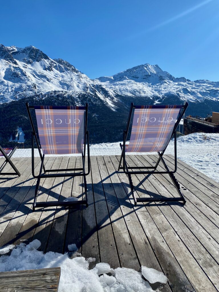 Paradiso club, Saint Moritz, après ski, shearling seat covers, The alps, elegant food in a rustic setting, alfresco dining, indoor outdoor living, Gucci lounge chairs, a chair with a view