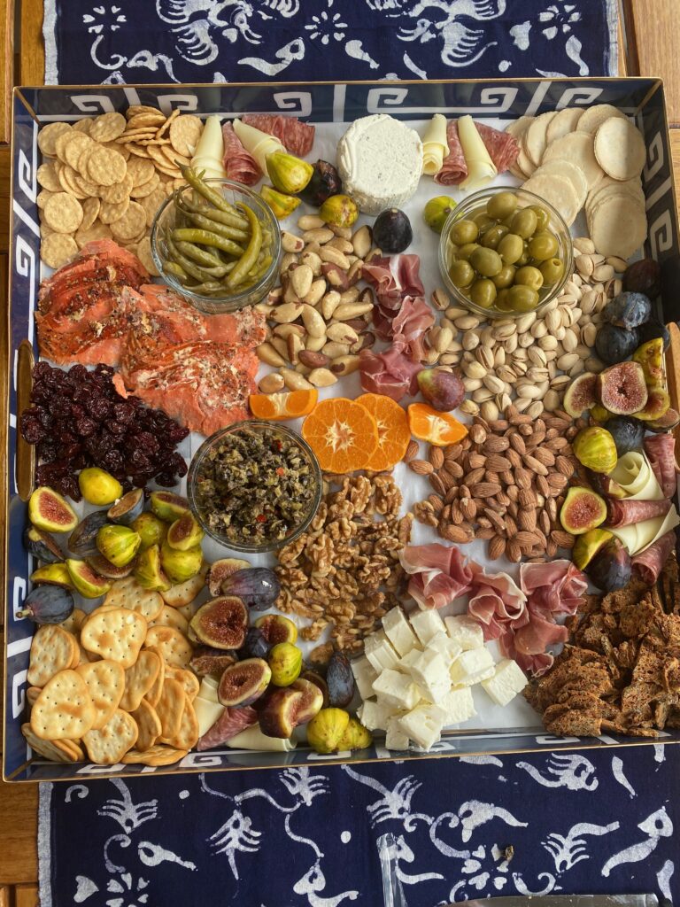 Splendid Party platter, crackers, pistachio nuts, dried sour cherries, blue and white tray, pickled peppers, olives, splendid fêtes, splendid food, Brazil nuts, cut oranges, Boursin cheese, tapenade, salami rolls, cheese rolls, smoked salmon, figs, tiger figs, mission figs, salted almonds, cheese chunks, walnuts 