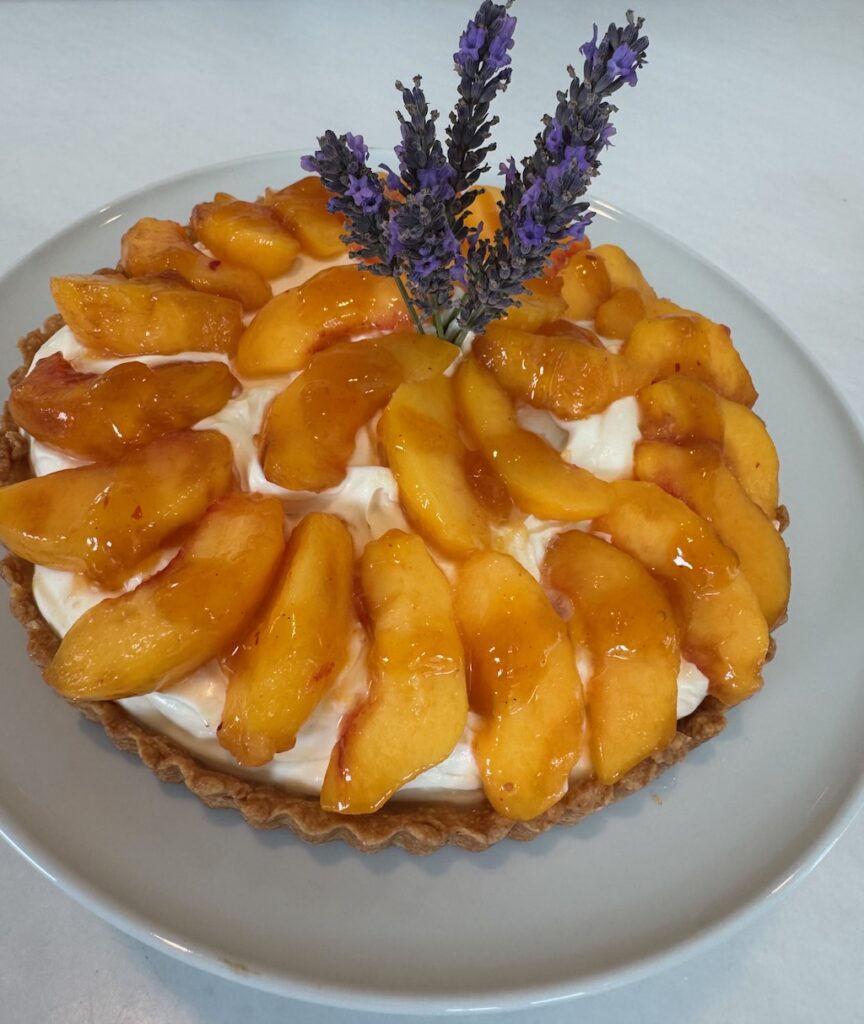 fresh peach tart, Pâte Brisée crust, mascarpone, créme fraîche filling, lavender sprigs