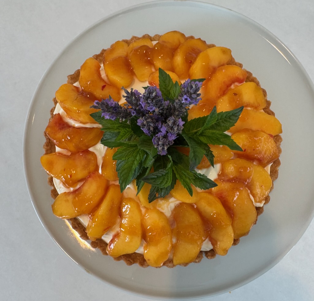 fresh peach tart, Pâte Brisée crust, mascarpone, créme fraîche filling, lavender sprigs, mint, crowning garnish
