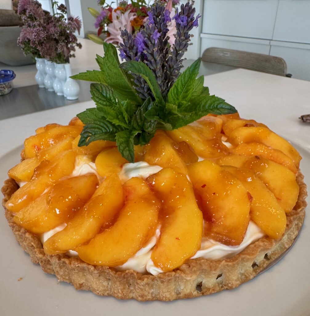 fresh peach tart, Pâte Brisée crust, mascarpone, créme fraîche filling, lavender sprigs, mint, crowning garnish